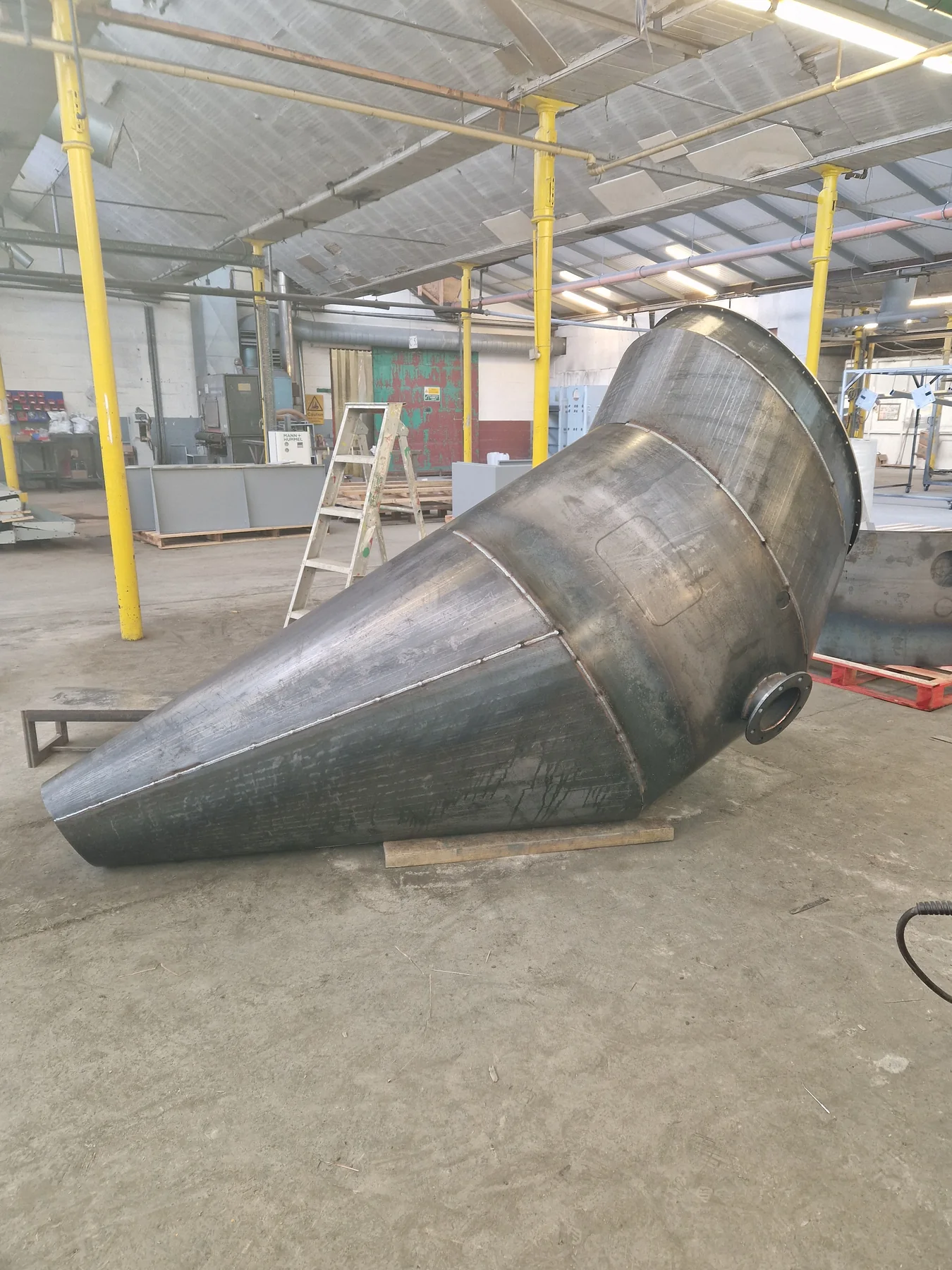 Raw workshop stage of a large conical fabrication