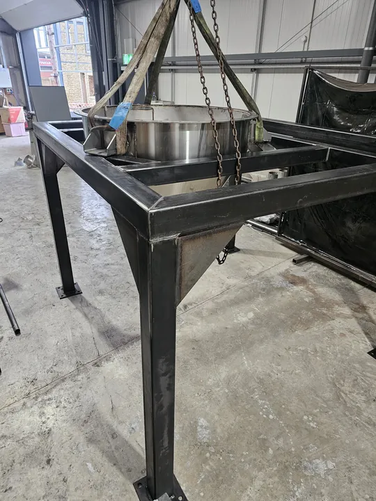Fabricated hopper within support frame